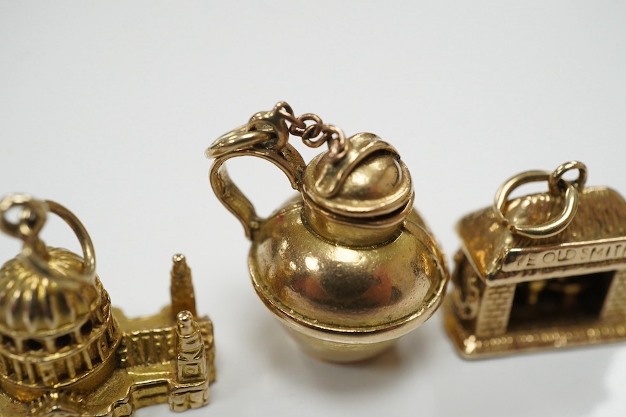 Three assorted 9ct gold charms, including Guernsey milk can and 'Ye Olde Smithy' and one other yellow metal charm, gross 14 grams. Condition - fair to good